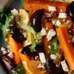 Colorful heart-healthy roasted vegetable bowl with sweet potatoes, black beans, mushrooms, spinach, and romesco sauce