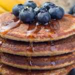 heart healthy stack of pancakes with blueberries and syrup