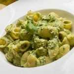 Bowl of pistachio pesto pasta with fresh basil and arugula, a heart-healthy dinner for blood pressure support