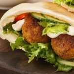 a pita bread sandwich with Falafel and vegetables