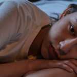 Woman sleeping peacefully after using a herbal insomnia treatment at bedtime