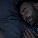 Young man sleeping peacefully at night