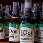 a shelf with bottles of cbd oil
