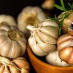 a bowl of garlic and cloves