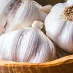 a bowl of garlic and cloves