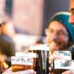 young people out have dinner and drinking beer