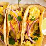 Breakfast tacos on wooden board