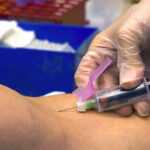 Blood draw tube used to test cortisol levels, showing symptoms of high vs low cortisol