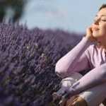 Woman Breathing Fresh Air Sitting In A Lavender Field