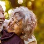 healthy senior couple enjoying a walk in the park