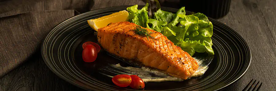 Collagen-rich foods for heart health including salmon and leafy greens on a plate