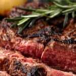 grilled flank steak on wooden cutting board