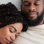 young couple asleep in bed