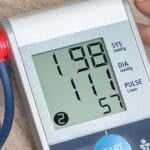 person checking the blood pressure with machine