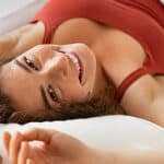 Happy woman waking up in the morning