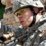 “A soldier in modern camouflage gear and helmet aims a rifle while pointing forward, standing inside a partially ruined brick building with sunlight and greenery visible outside.”